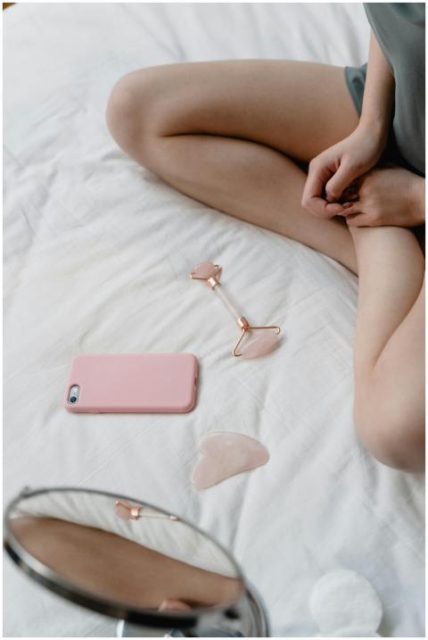 A calming spa scene with a facial roller and phone