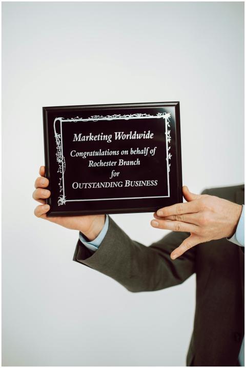 Close-up of hands holding a business award plaque