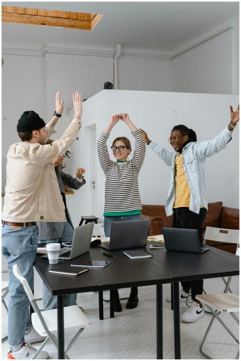 A multicultural group of professionals celebrating