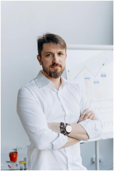 Confident businessman in white shirt posing in fro