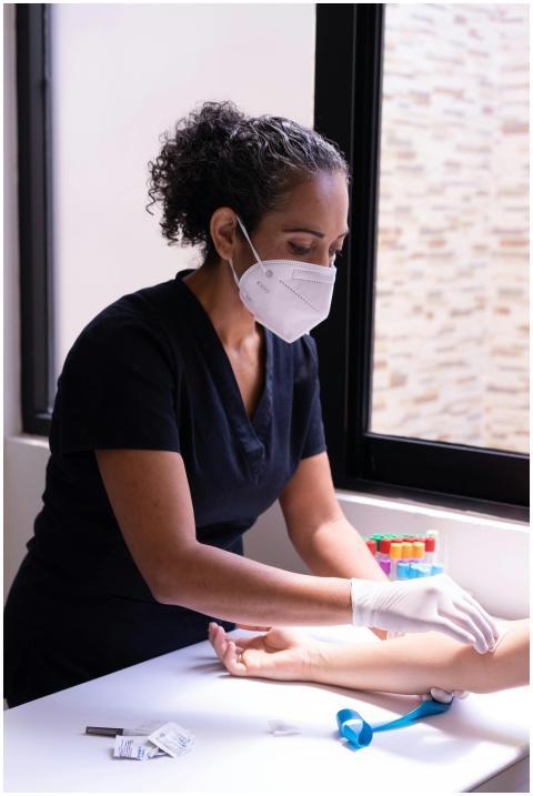 Professional nurse prepares a patient for a blood