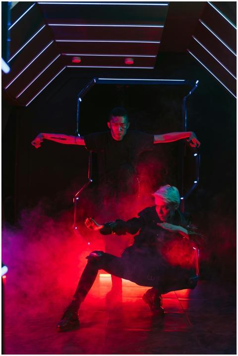 Fashionable individuals pose in a futuristic, neon