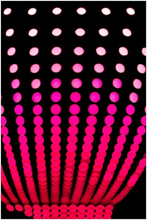 Abstract vibrant pink and red polka dot pattern on