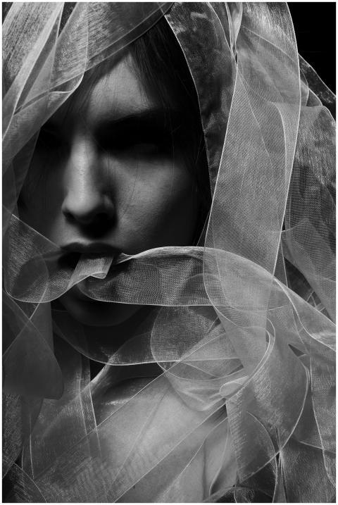 Monochrome portrait of a young woman with a veil,