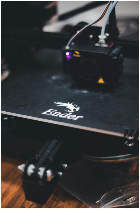 Detailed view of a 3D printer working on a design