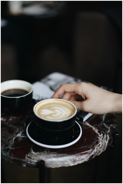 Elegant cappuccino with heart latte art on marble