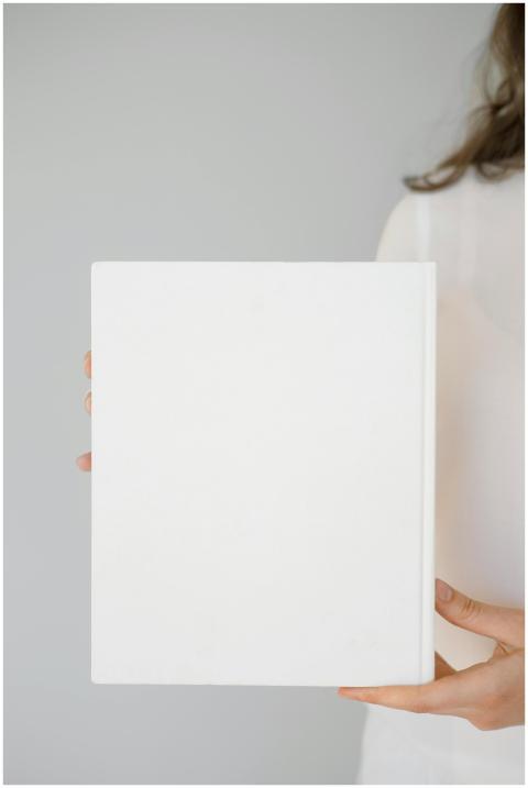 Minimalist close-up of a woman holding a blank whi