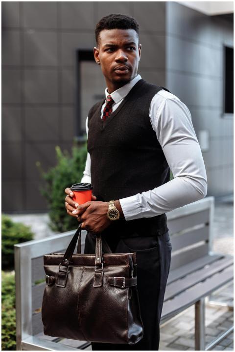 Confident man in professional attire holding a cof