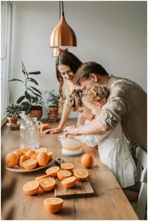 A family enjoys squeezing fresh orange juice toget