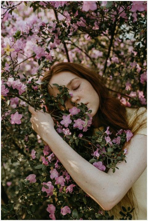A serene portrait of a woman intertwined with bloo