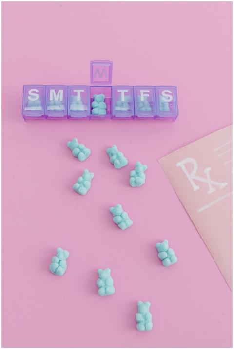 Colorful weekly pill organizer with blue pills sca