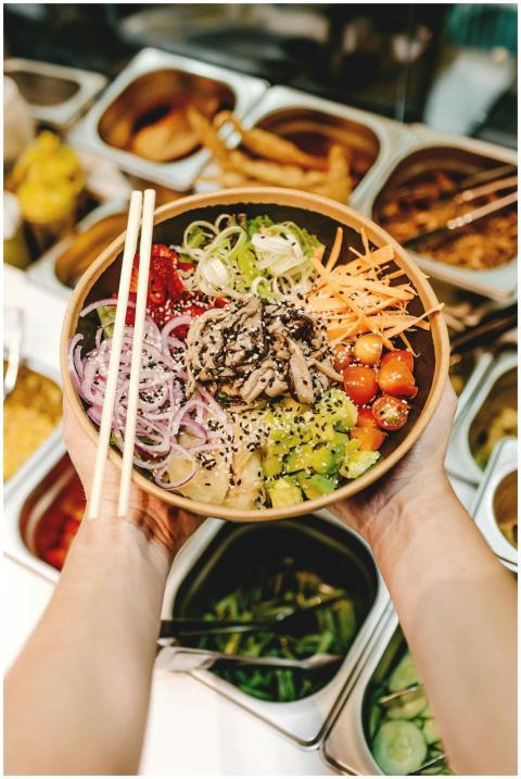 A healthy Asian salad bowl topped with fresh veget