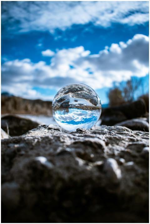 A crystal ball reflecting the sky and clouds creat