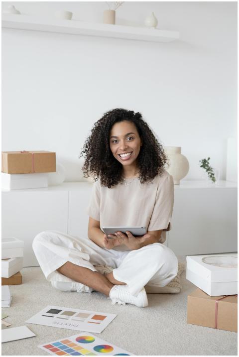 A confident young woman sitting among packages and