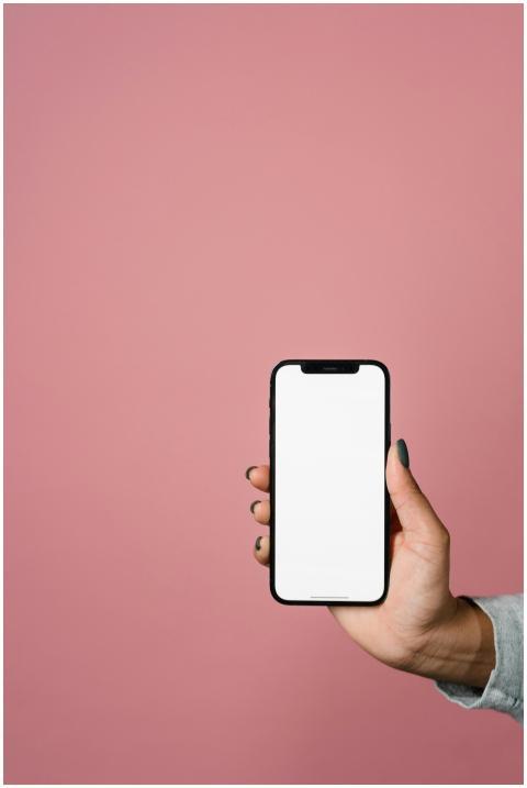 A close-up of a hand holding a smartphone with a b