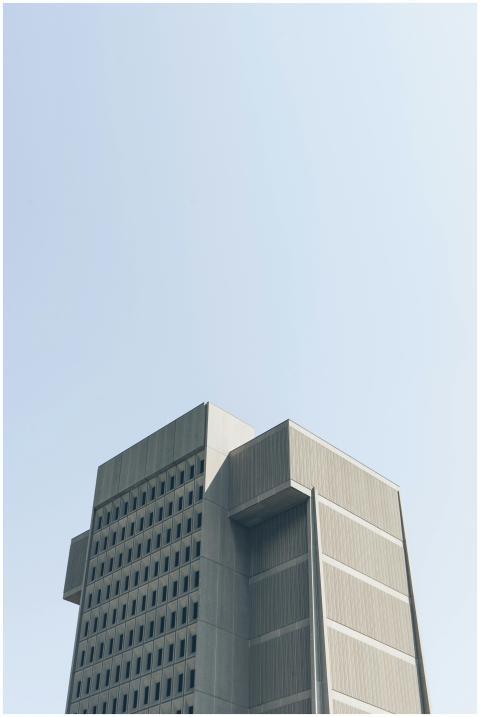Tall, modern building against a clear blue sky in