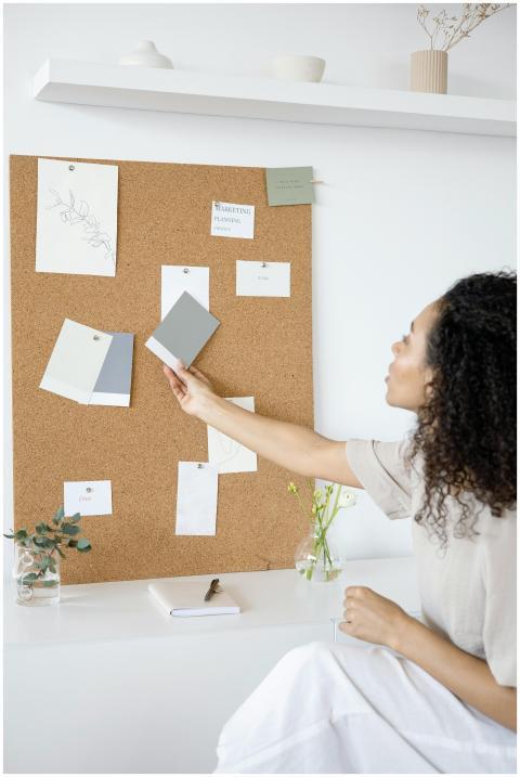 A woman curates a mood board in a minimalist home
