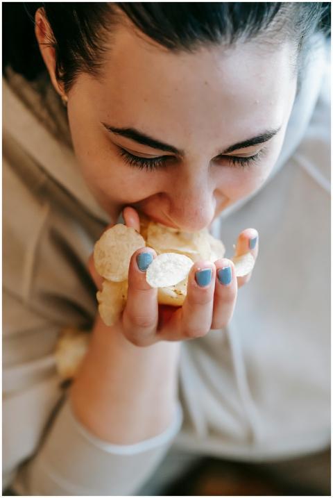 From above of crop female in sweater with black ha