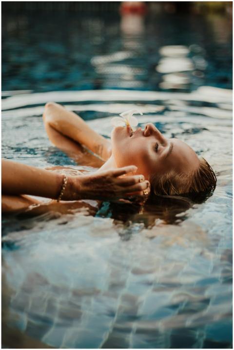 Woman with eyes closed floating peacefully in a Ba