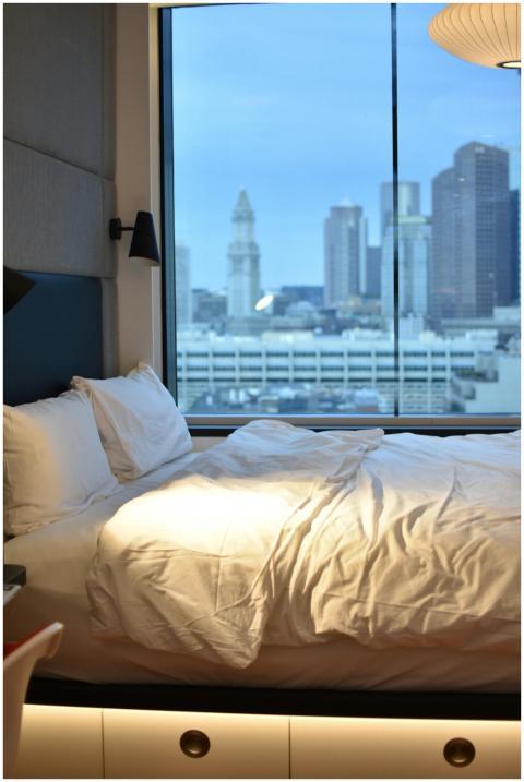 Modern hotel room overlooking Boston skyline, feat