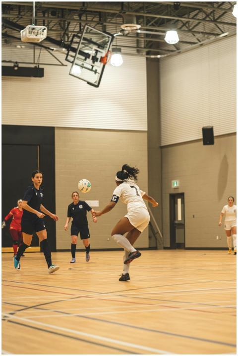 Dynamic indoor soccer match with women players sho