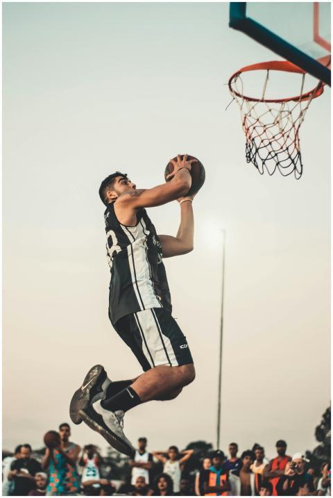 Athlete gracefully performs a dunk during an outdo
