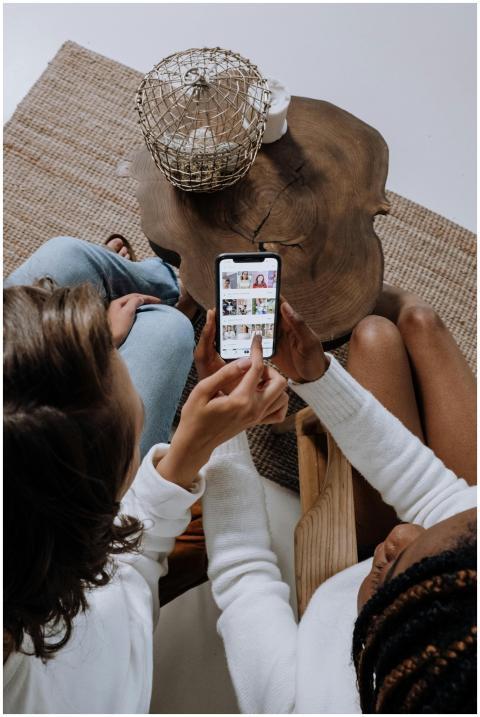 Two people looking at social media on a smartphone