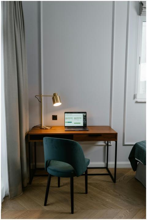 Modern home office setup with a laptop, lamp, and