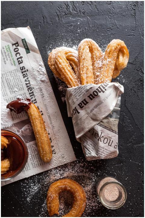Freshly made churros dusted with sugar, wrapped in