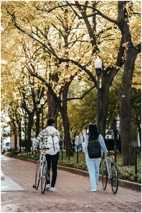 A couple enjoying a leisurely walk with bikes thro
