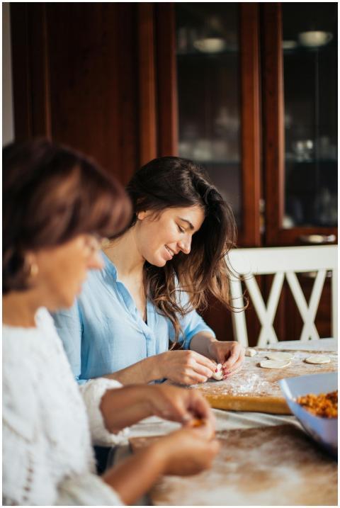 Two women preparing traditional pelmeni together i