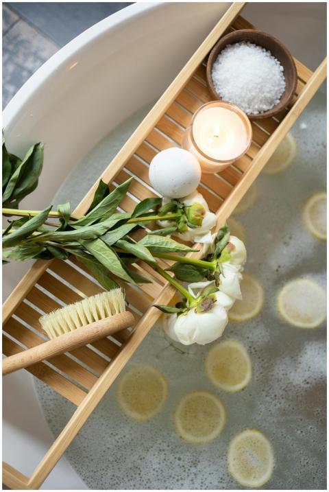 Top view of wooden tray with bath bomb and burning