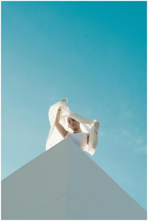 Artistic shot of a woman in white against a clear