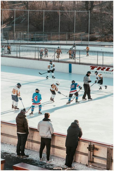A lively youth ice hockey match at an outdoor rink