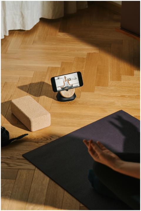 A serene home yoga setup with phone streaming clas