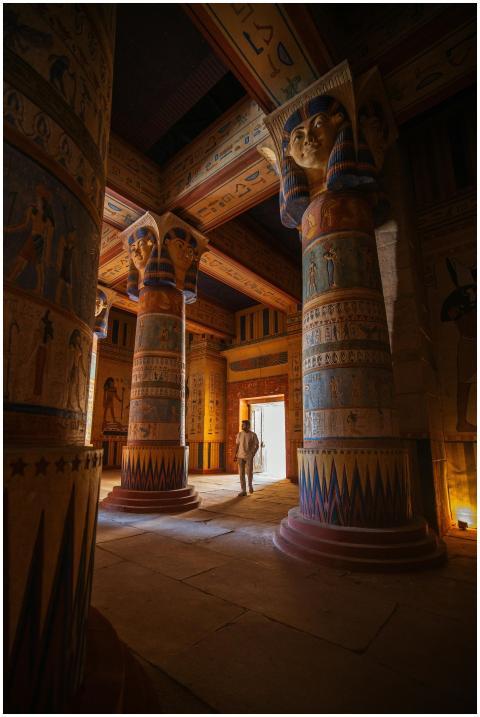A traveler walks through a majestic ancient Egypti