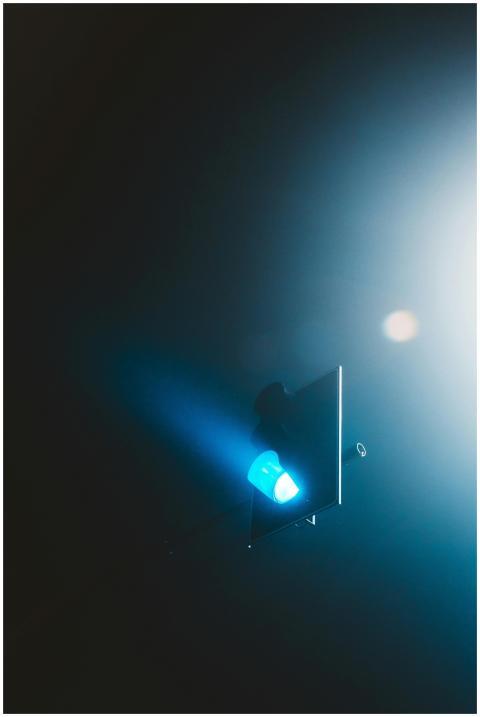 Moody streetlight in the foggy night, casting an e