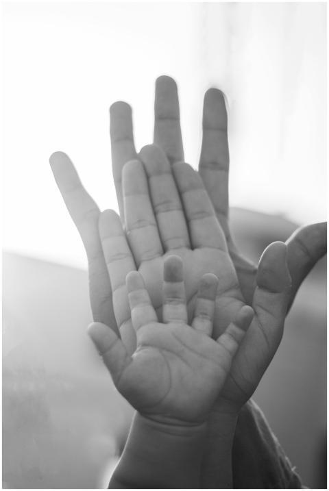 Black and white image of family hands symbolizing