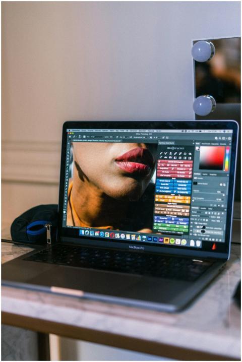 A laptop displaying a graphic design software inte