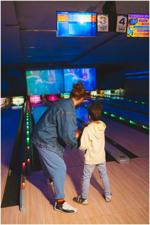 Adult and child enjoying a fun night at the bowlin