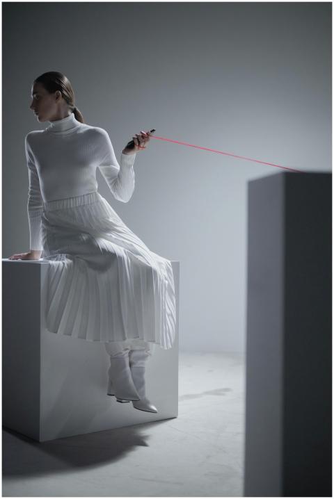 Elegant woman in white fashion sitting in a minima