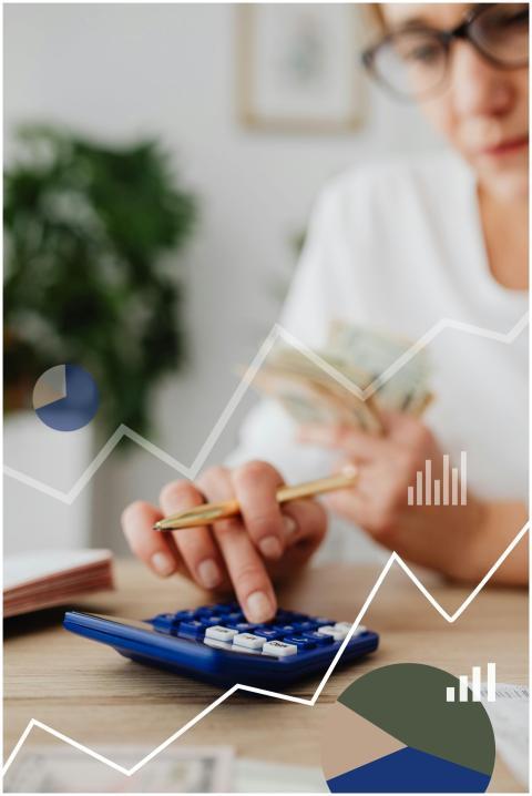 Woman using calculator with financial graph overla