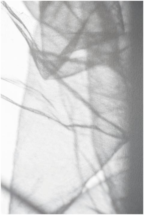 Abstract shadows casting over delicate white fabri