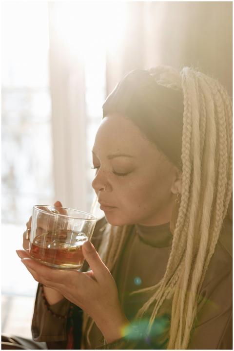 Woman with braids enjoys a moment of relaxation wh