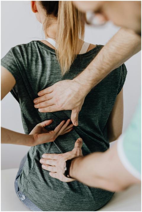 Chiropractor performs manual adjustment on a patie