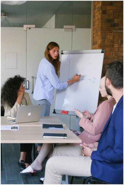 Pensive employee in formal clothes drawing graph o