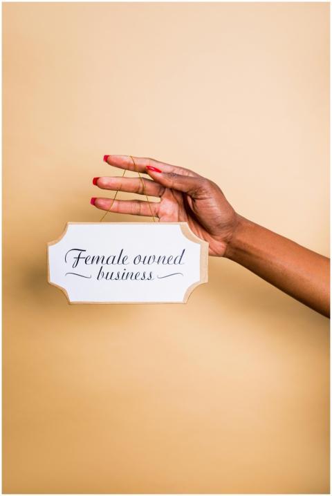Close-up of a hand holding a female-owned business