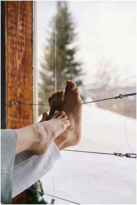 Relaxing indoors with a snowy mountain view, feet