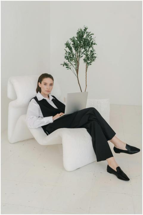 Confident businesswoman in a suit working on a lap