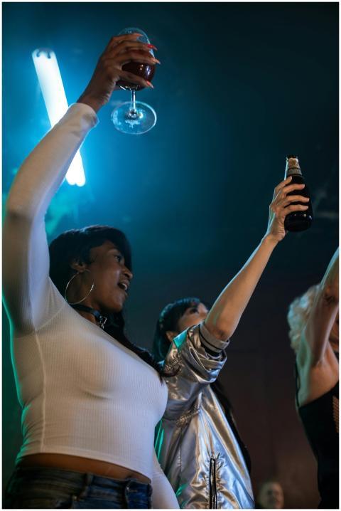 Lively night out with friends raising glasses in a